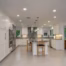 Modern white kitchen with recessed ceiling lights and layered lighting designed to improve visibility for aging-in-place home design.